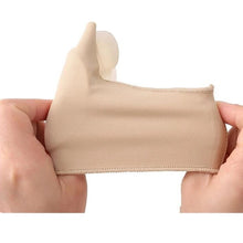 Load image into Gallery viewer, Hands stretching a single beige bunion corrector splint showing fabric flexibility