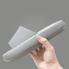 Load image into Gallery viewer, Hand holding light grey Cloud Slide showing ribbed upper and chunky sole