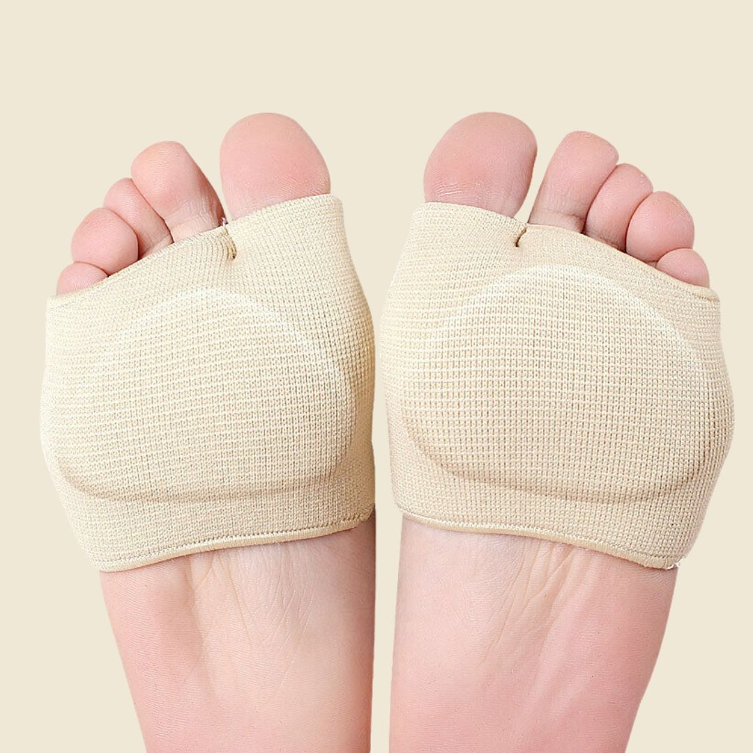 Beige gel metatarsal pad sleeves worn on both feet, bottom view showing open-toe design and cushioned ball-of-foot padding