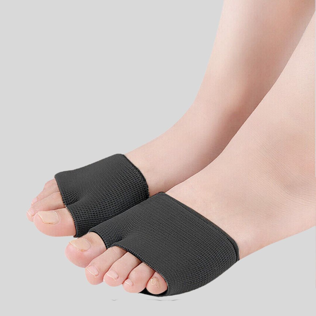 Black metatarsal pad sleeves worn on both feet, side angle showing open-toe elastic fit across the ball of the foot