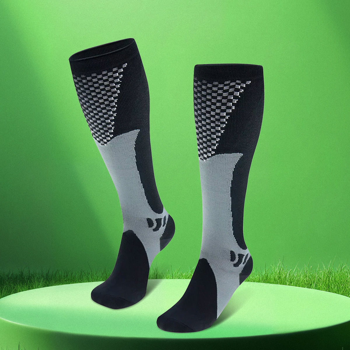 Pair of black grey LegEase Compression Socks on green display platform