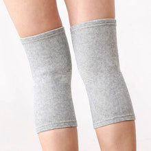 Load image into Gallery viewer, Both legs wearing grey bamboo compression knee supports, showing subtle cross pattern detail