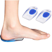 Load image into Gallery viewer, Bare foot standing on a Comfort Heel Cup silicone insole, with two heel cups shown separately beside the foot