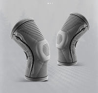 Pair of grey Ultra Knee Braces displayed side by side on grey background