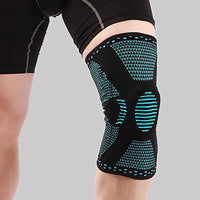Teal and black Ultra Knee Brace worn on a person's knee, front view showing compression pattern