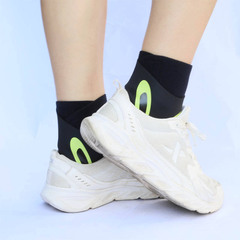 Black and green Plantar X Wrap worn with white sneakers side view
