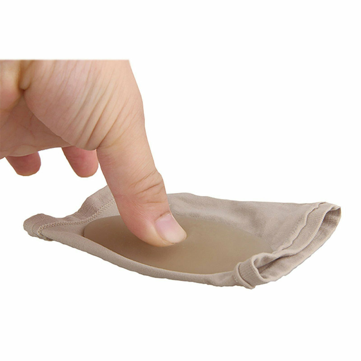 Finger pressing into cushioned gel pad of beige Foot Arch Support Sleeve