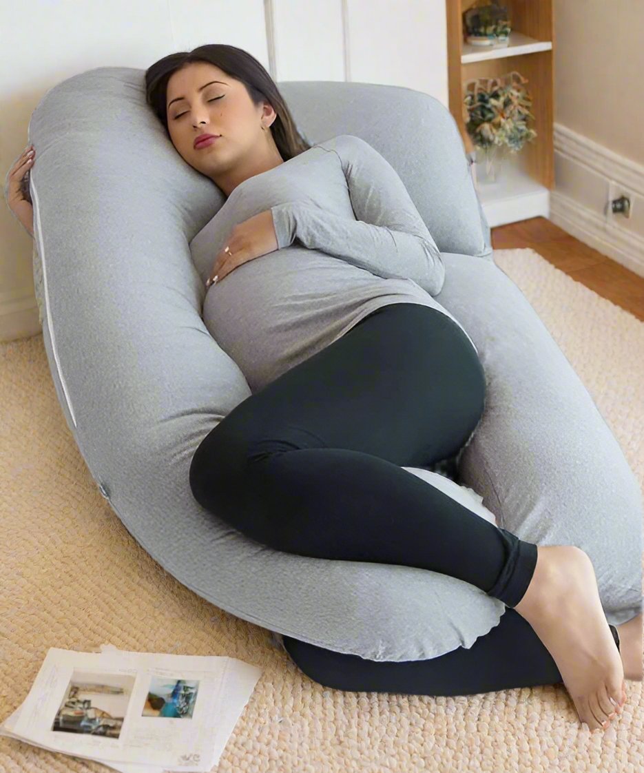 Pregnant woman sleeping on grey Full Body Pillow on living room floor