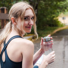 Load image into Gallery viewer, Woman in activewear holding hydrogen water bottle generator outdoors on path