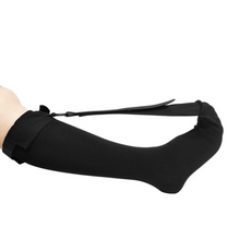 Load image into Gallery viewer, Black plantar fasciitis night splint sock lying flat showing foot strap and calf band, side view on leg