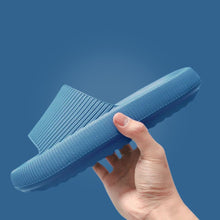 Load image into Gallery viewer, Hand holding light blue Cloud Slide showing thick sole and ribbed upper
