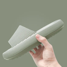 Load image into Gallery viewer, Hand holding sage green Cloud Slide showing ribbed upper and chunky sole

