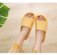Yellow Cloud Slides top-down view on feet, timber floor