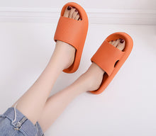 Load image into Gallery viewer, Orange Cloud Slides on legs raised against white wall
