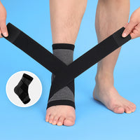 Hands wrapping black grey Compression Ankle Sleeve straps around bare ankle
