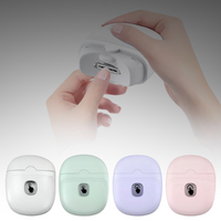 Hand demonstrating blade button on white electric nail clipper with four colour variants below
