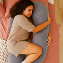 Load image into Gallery viewer, Overhead view of woman hugging grey Full Body Pillow on pink bed
