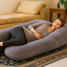 Load image into Gallery viewer, Woman resting on grey Full Body Pillow on floor beside yellow sofa
