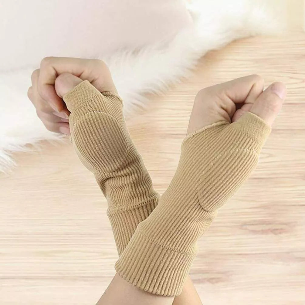 Pair of beige gel thumb support gloves worn on both fists against a soft white background