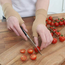 Load image into Gallery viewer, Person wearing beige wrist support gloves chopping cherry tomatoes on a wooden board
