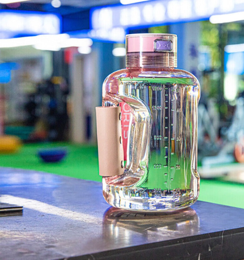 Pink large-capacity hydrogen water bottle generator on bench in gym setting