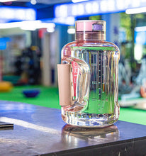 Load image into Gallery viewer, Pink large-capacity hydrogen water bottle generator on bench in gym setting
