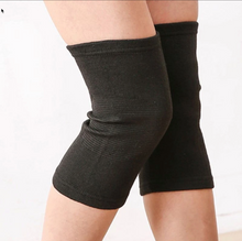Load image into Gallery viewer, Pair of black bamboo compression knee support sleeves worn on both legs, front view
