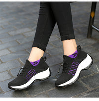 Black and purple Orthopaedic Comfort Shoes for Women on cobblestone pavement