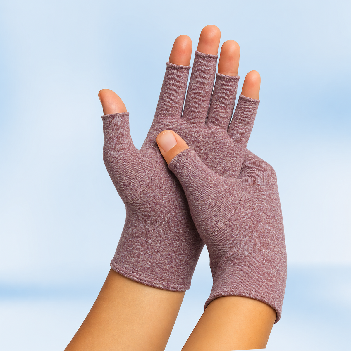 Mauve Therapeutic Heat Gloves pair raised against light blue background