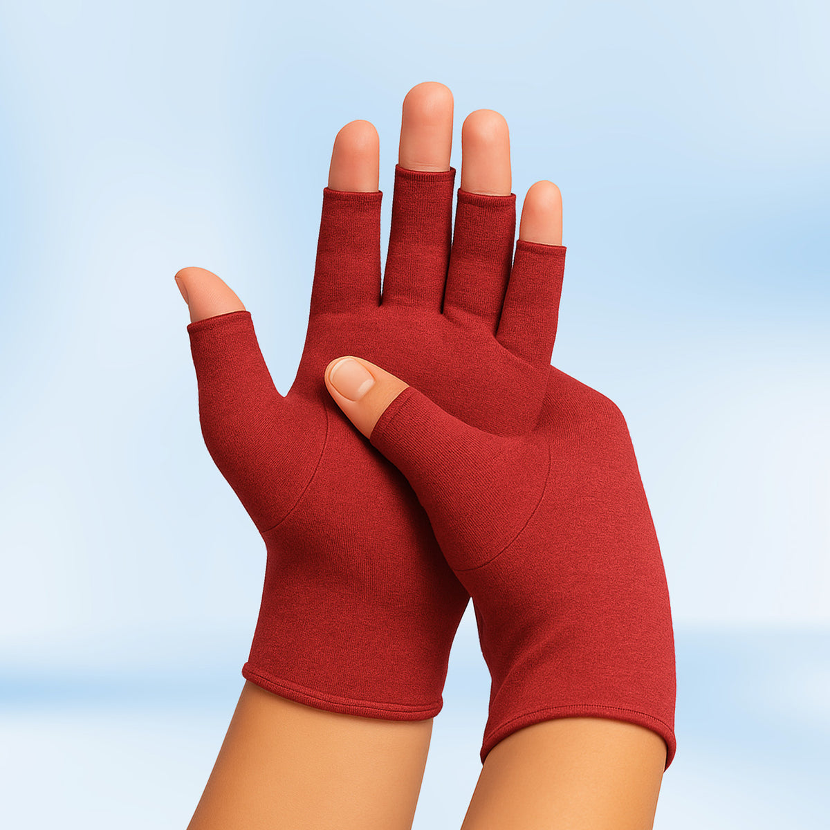 Pair of red Therapeutic Heat Gloves raised against light blue background