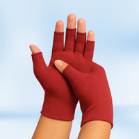 Pair of red Therapeutic Heat Gloves raised against light blue background