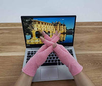 Pink Therapeutic Heat Gloves worn while typing on laptop keyboard