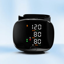 Load image into Gallery viewer, Black wrist blood pressure monitor front view on light blue background showing SYS 120, DIA 80, PUL readings
