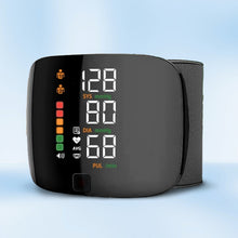 Load image into Gallery viewer, Angled front view of black wrist blood pressure monitor with colour-coded indicator lights and dual-user display
