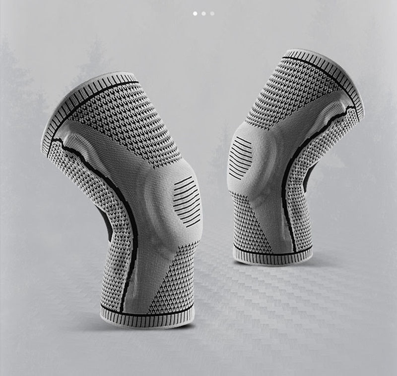 Pair of grey Ultra Knee Braces displayed side by side on grey background
