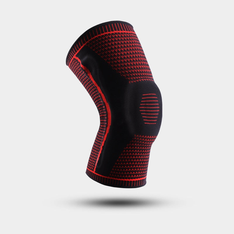 Red and black Ultra Knee Brace floating on white background, angled side view