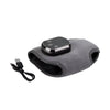 Ankle heating wrap laid flat beside a USB charging cable on white background