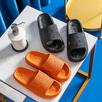 Black and orange Cloud Slides with water droplets on marble surface