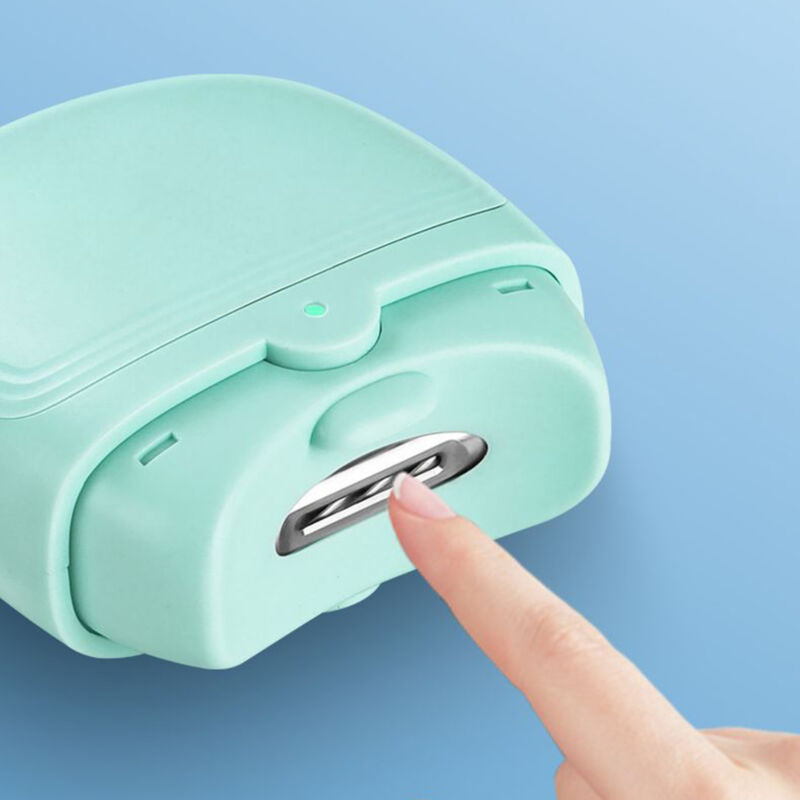 Close-up of a finger pressing the blade button on a mint green electric nail clipper