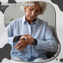 Load image into Gallery viewer, Older woman wearing a black wrist support glove holding her wrist in pain, with relieve joint pain text overlay
