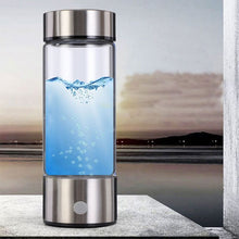Load image into Gallery viewer, Silver hydrogen water bottle generator with blue water and rising bubbles inside
