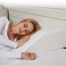 Load image into Gallery viewer, Woman resting her head on a wedge pillow while lying on her side in bed
