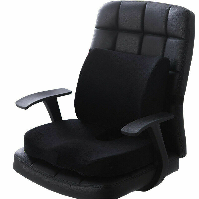 Black lumbar support and seat cushion set fitted to a black leather office chair