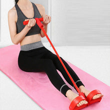 Load image into Gallery viewer, Woman seated on pink yoga mat pulling red Multifunction Resistance Band handles toward her chest
