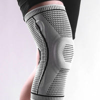 Grey Ultra Knee Brace worn on a person's knee, side profile view showing knitted compression fabric