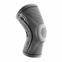 Load image into Gallery viewer, Single grey Ultra Knee Brace on white background, front three-quarter view showing silicone kneecap pad
