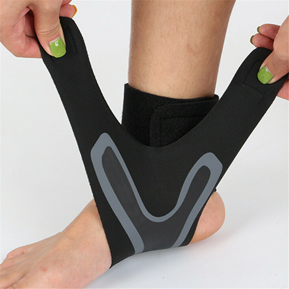 Hands pulling black and grey Plantar X Wrap straps around bare ankle